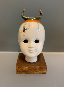 Porcelain doll head steer horn with orange and spider decal
