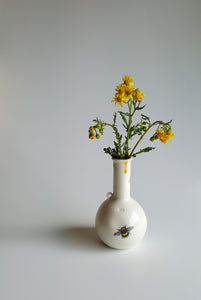 Round bottle with Bee Design and yellow dribble