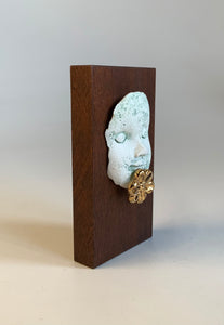 Block head with gold flower chin