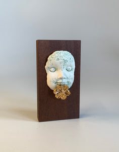 Block head with gold flower chin